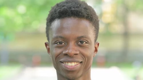 Close-up of a Smiling Young African Man Face