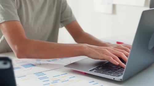 Close-up Young Asia girl IT development programmer typing on keyboard coding programming fixing data