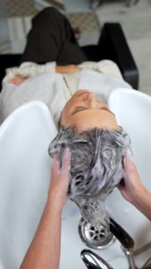 Woman Getting Hair Washed at Salon