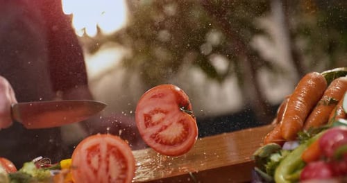 Man aggressively cutting a tomato