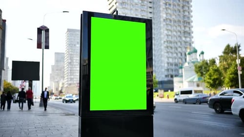 Green Screen Advertising Billboard Mockup on a City Street with Traffic and Buildings