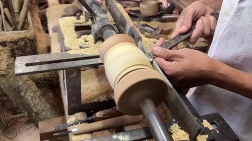 Man Shaping Wood on Lathe