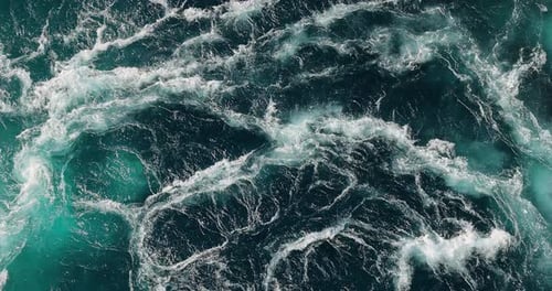 Blue waves of water of the river and the sea meet each other during high tide and low tide.