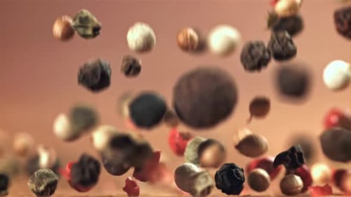 Multi-Colored Peppercorns Falling in Slow Motion