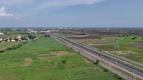 Aerial footage of a highway running through Amaravathi’s vast green farmlands.