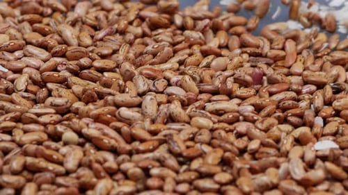 A pile of beans on a table, close-up of brown and red beans