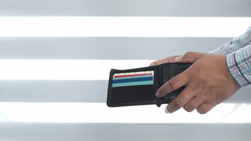 Mexican man takes money from his wallet to pay, slow-motion