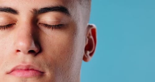 Closeup, face and man with skincare, cosmetics and dermatology on blue studio background