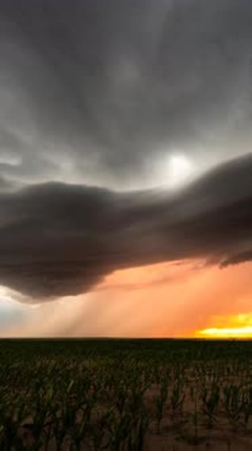 Dramatic Storm Clouds Over Field at Sunset