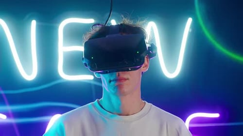 Young Adult Wearing VR Headset with Neon Lights