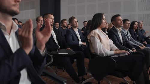 Audience Clapping at a Corporate Presentation or Conference