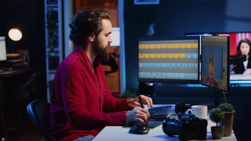 Man Editing Photos on Graphics Tablet at Desk