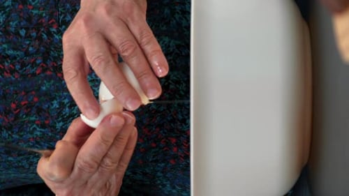 Close Up of Hands Cutting an Egg