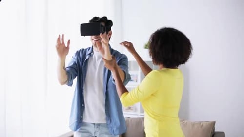 Man uses VR headset with woman in home