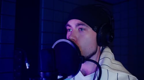 Young Male Singer Recording a Track in Audio Studio