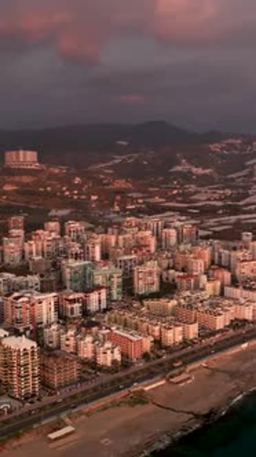 Vertical Video Coastal Serenade Aerial View of a Beautiful Sunset Over the Sea