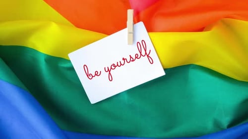 Zoom in Out Rainbow Flag with Text BE YOURSELF Message on Paper Note