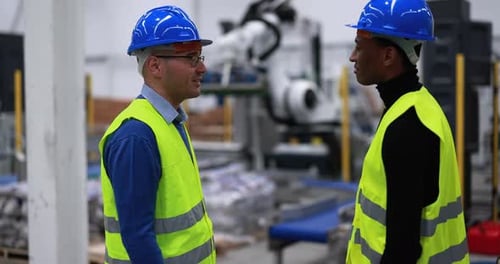 Multiethnic Engineers Working Inside Robotic Factory - Industrial And Technology