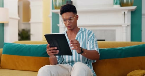 Smile, relax and tablet with man on sofa for online reading, communication and social media post