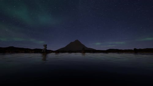 Stunning Aurora Borealis Over a Mountain Reflected in Still Water at Night