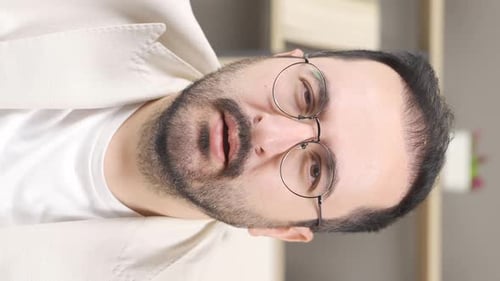 Vertical video of Flu man sneezes.