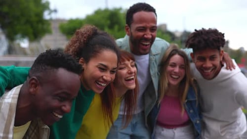 United Group of College People Having Fun Laughing Together Outdoors