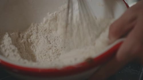 Pastry Chef Whisking Flour On Bowl For Dough In The Kitchen. - close up shot