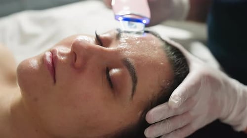 Spa Therapist Removing Pimples With Extraction Tool During Acne Treatment