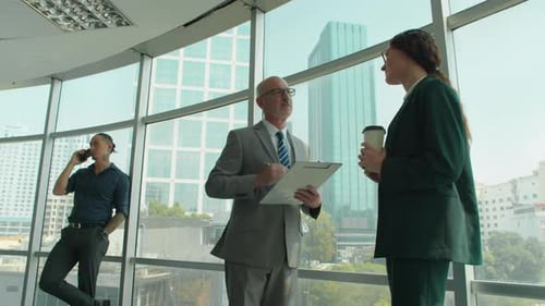 Business Colleagues Discussing Plans in Office Building