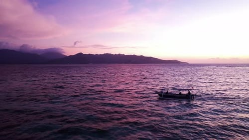 Serene Sunset Over the Sea with a Boat and Mountain Silhouette