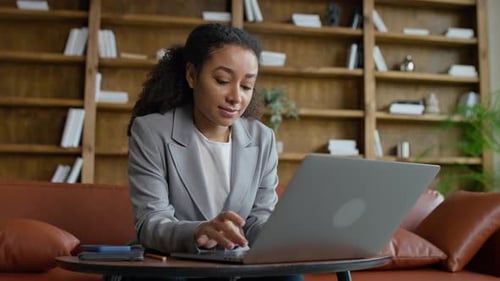 Young Businesswoman Working on Laptop in Office