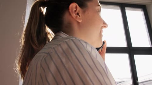 Woman Smiling while Talking on Phone Inside Home
