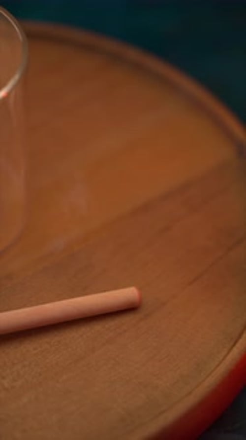 Wooden Spoon and Lid Beside Empty Jar on Stand in Muted Space