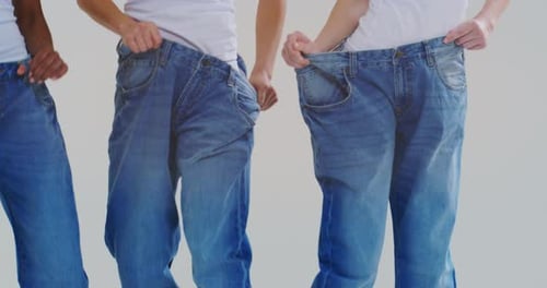 Women Showing Weight Loss in Oversized Jeans
