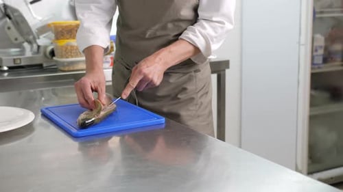 Chef Filleting Fresh Fish with Precision Knife Skills