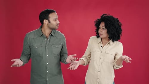 Man and African American Woman Spread Hands in Confusion
