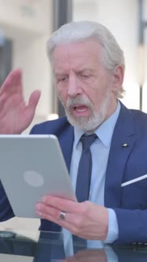 Old Businessman with Loss on Tablet in Office, vertical video