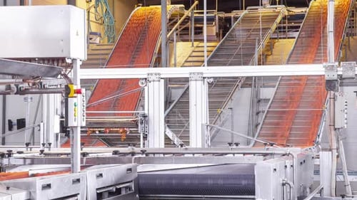 Automated Industrial Conveyor System Moving Goods Through a Modern Factory Facility