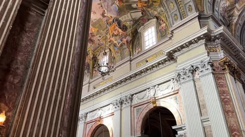 Reveal Shot Of Marble Walls And Painted Ceilings In Sant'lgnazio di Loyola Church In Rome, Italy.