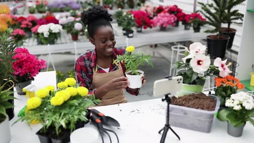 Woman Records Gardening Tutorial in Plant Shop