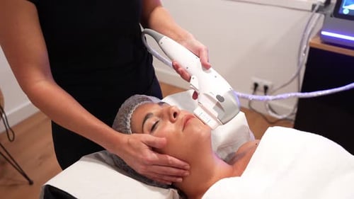 Woman Receiving Non-Invasive Facial Treatment at Medical Spa