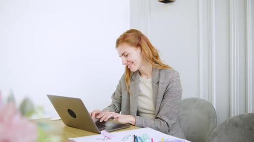 Young Woman Working on Laptop at Home