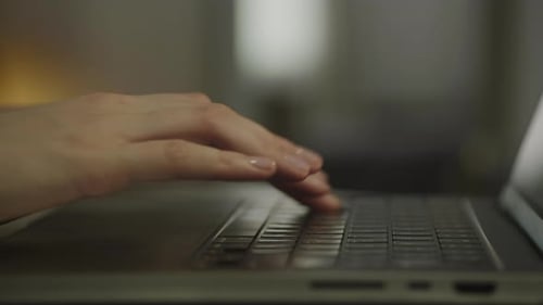 Woman Hands Typing on Laptop Keyboard Close Up