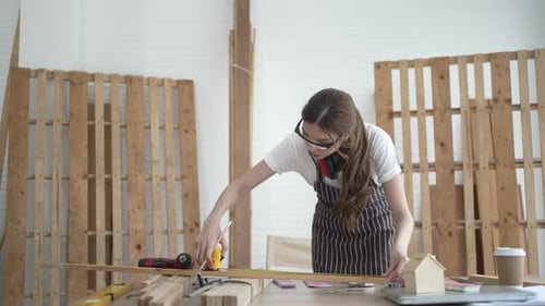 Carpenters are working at workshop.