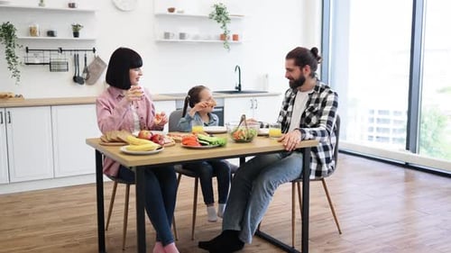 Family Eating Lunch Together at Kitchen Table