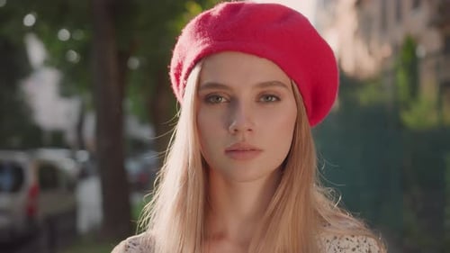 Young Adult in Red Beret Standing Outdoors