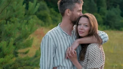 Affectionate Couple Embracing Outdoors in Natural Setting