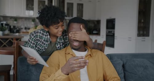 Loving Child Surprises Father with a Handmade Card