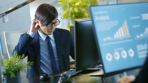 In the Office Agitated Businessman works on a Desktop Personal Computer, He's Overworked and Drinks