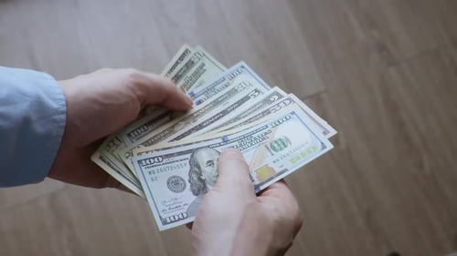 Hands Counting United States Dollar Bills